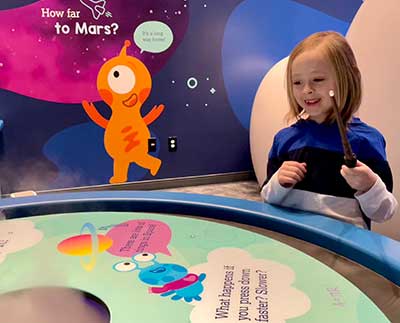 Kid playing at the Orbits Curiosity Zone at Lowell Observatory Flagstaff